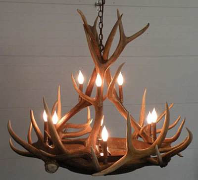 This chandelier from the Peak Antler Company provides a beautiful amber glow through the mica tiers while retaining a rustic elegance feel of an antler chandelier. Medium and small elk antler circle the center with tall patina coated copper sleeves for the 9 candles. This chandelier is custom built by the artist in Colorado USA.