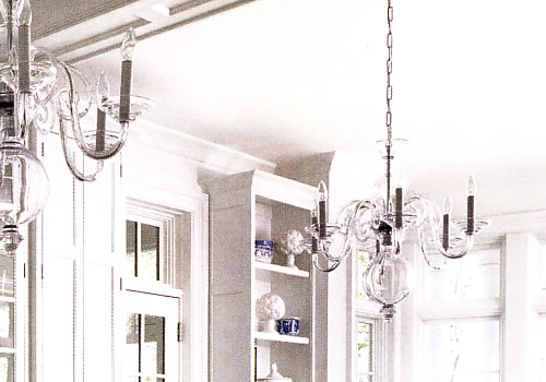 "Enhanced by a pair of elegant crystal chandeliers, the all white kitchen exudes glamour." Traditional Home February March 2014