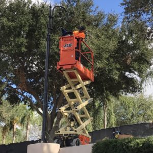 Man on cherry picker converting street lighting to LED