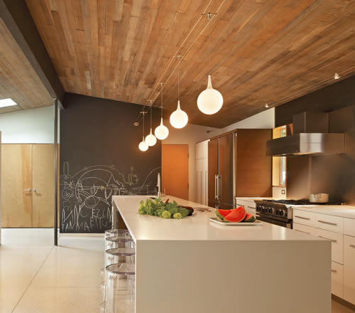 Tech Lighting Pele pendants suspended from Tech Lighting Kable run wall to wall below an exposed wood ceiling Lightweight pendants can be suspended from cable using the free-jack connector.