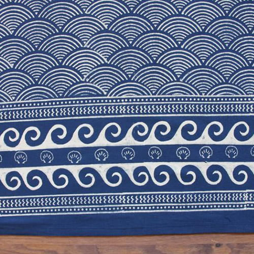 Saffron Marigold Pacific Blue: Ivory waves patterned rhythmically across a deep navy / indigo blue ground.