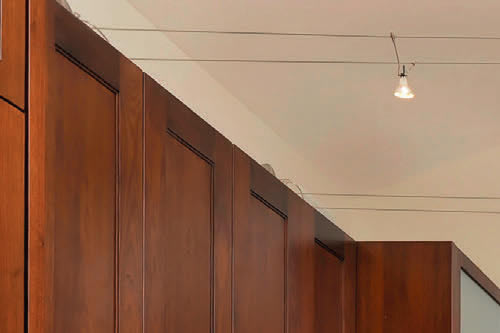 Tech Lighting K-Jane Light Transformers are above the cabinets on this side Kitchen with Cable Lighting