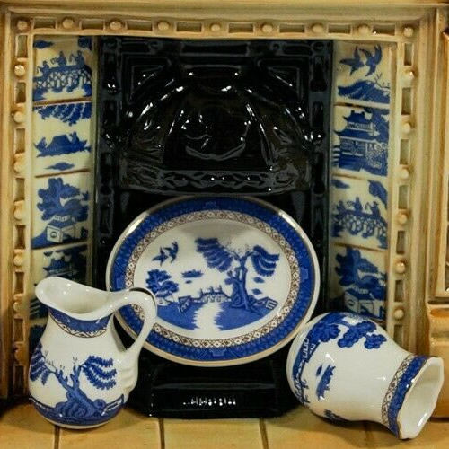 The hearth has Blue Willow Tiles and a plate, pitcher and vase with the Royal Doulton Old Willow Pattern