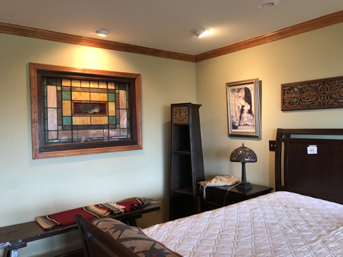 Bedroom with stained glass, Arts & Crafts clock shelf, stained glass lamp, Indian blanket