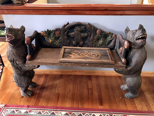 Bench with carved bears and branches at the Auction Preview at Indian Cave Lodge