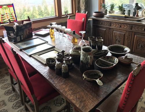 Indian Cave Lodge Dining Room with a rustic table and red chairs with brass tack accents