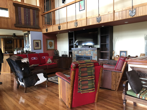 The living room furniture has red wool Chimayo weavings on the cushions