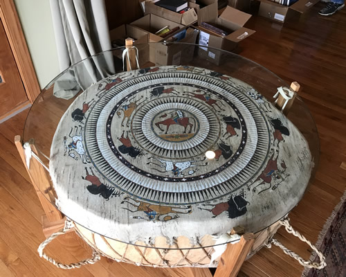 Glass top table with an Indian Drum looking base